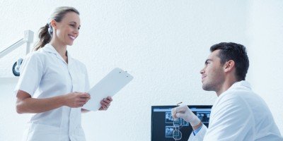 Dental Adminstrator Communicating with Dentist